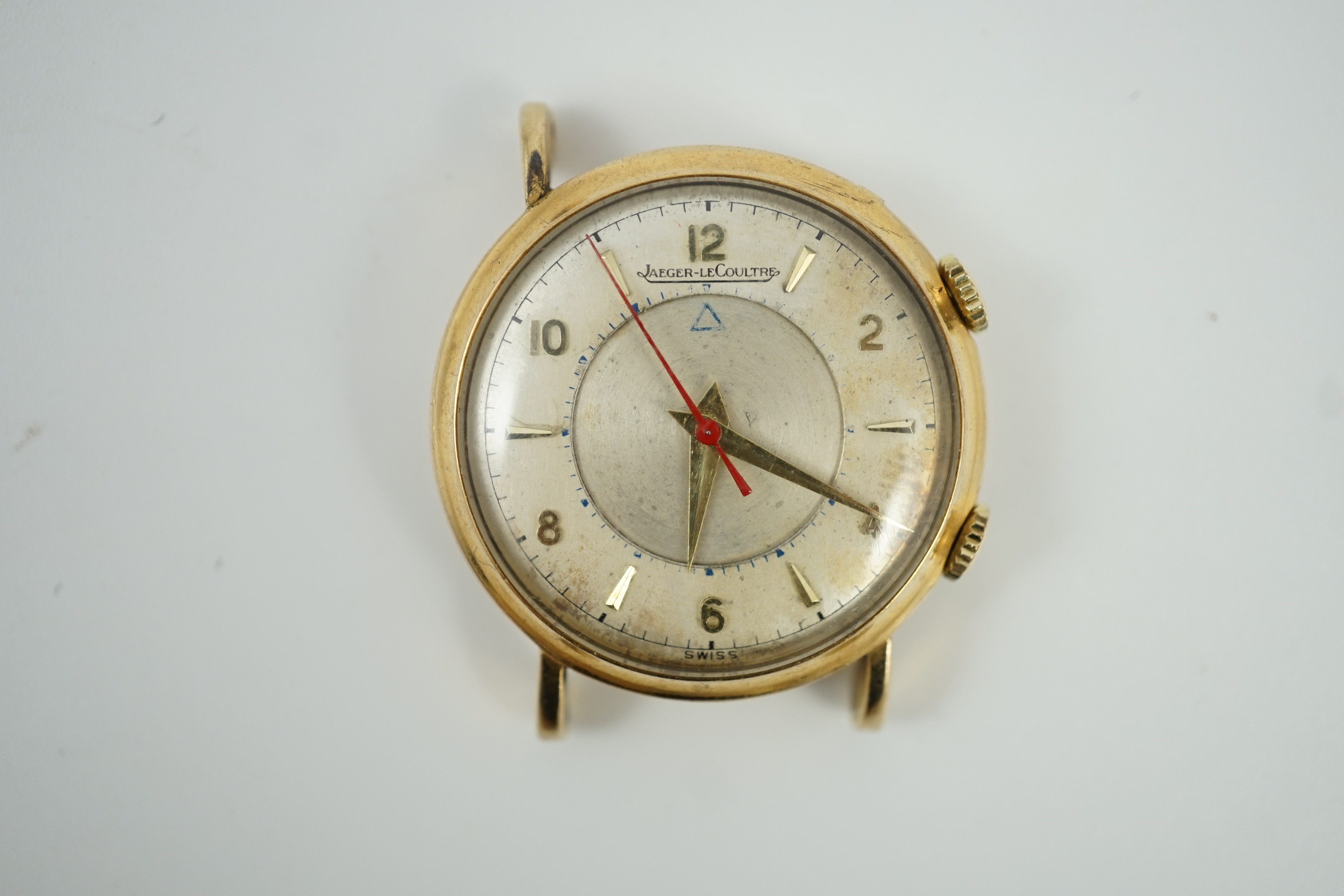 A gentleman's 9ct gold Jaeger LeCoultre memovox wrist watch, with case back inscription and lacking one lug, case diameter 32mm, gross weight 26.4 grams.